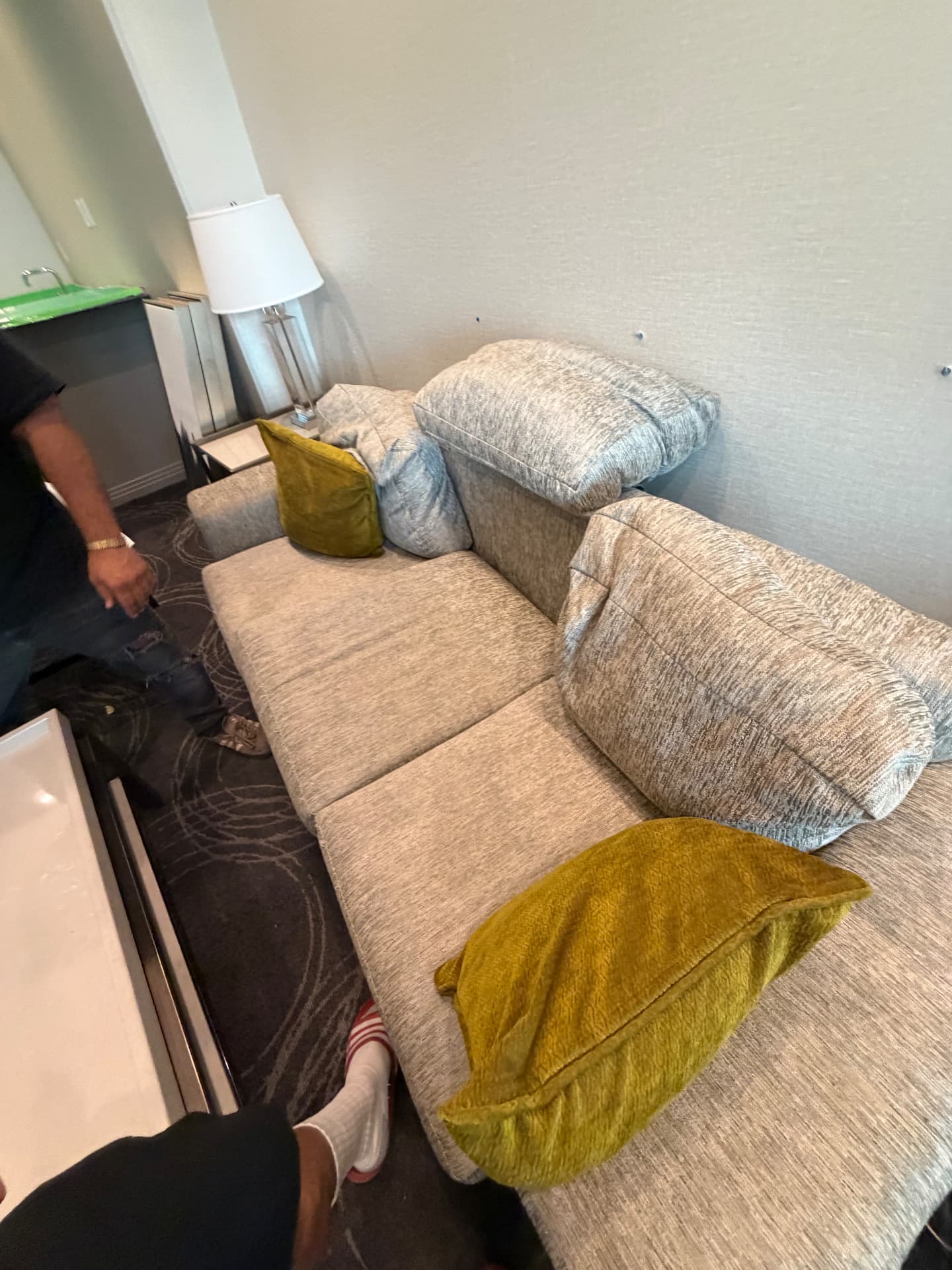 Suite sofa bed with accent pillows, table lamp and side table