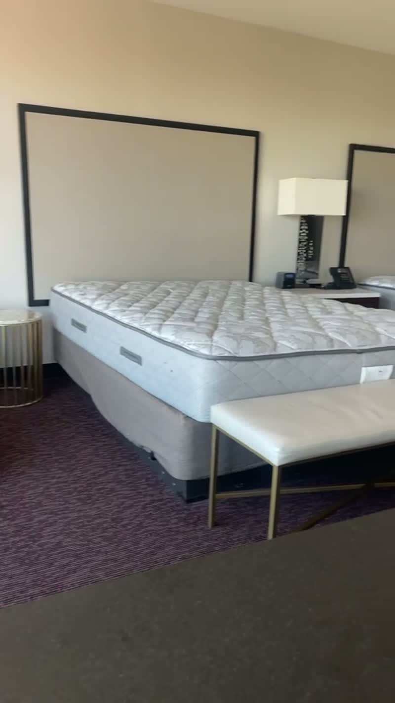 Walkthrough video of a classic guest room with beds, headboard, nightstand and lamps