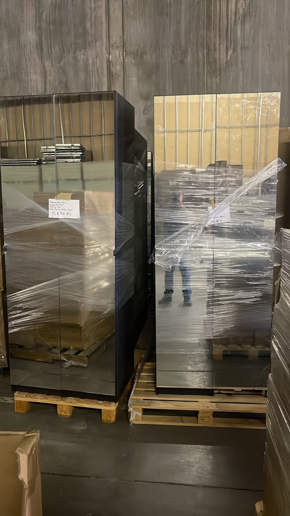 Brand-new mirrored armoires wrapped on pallets