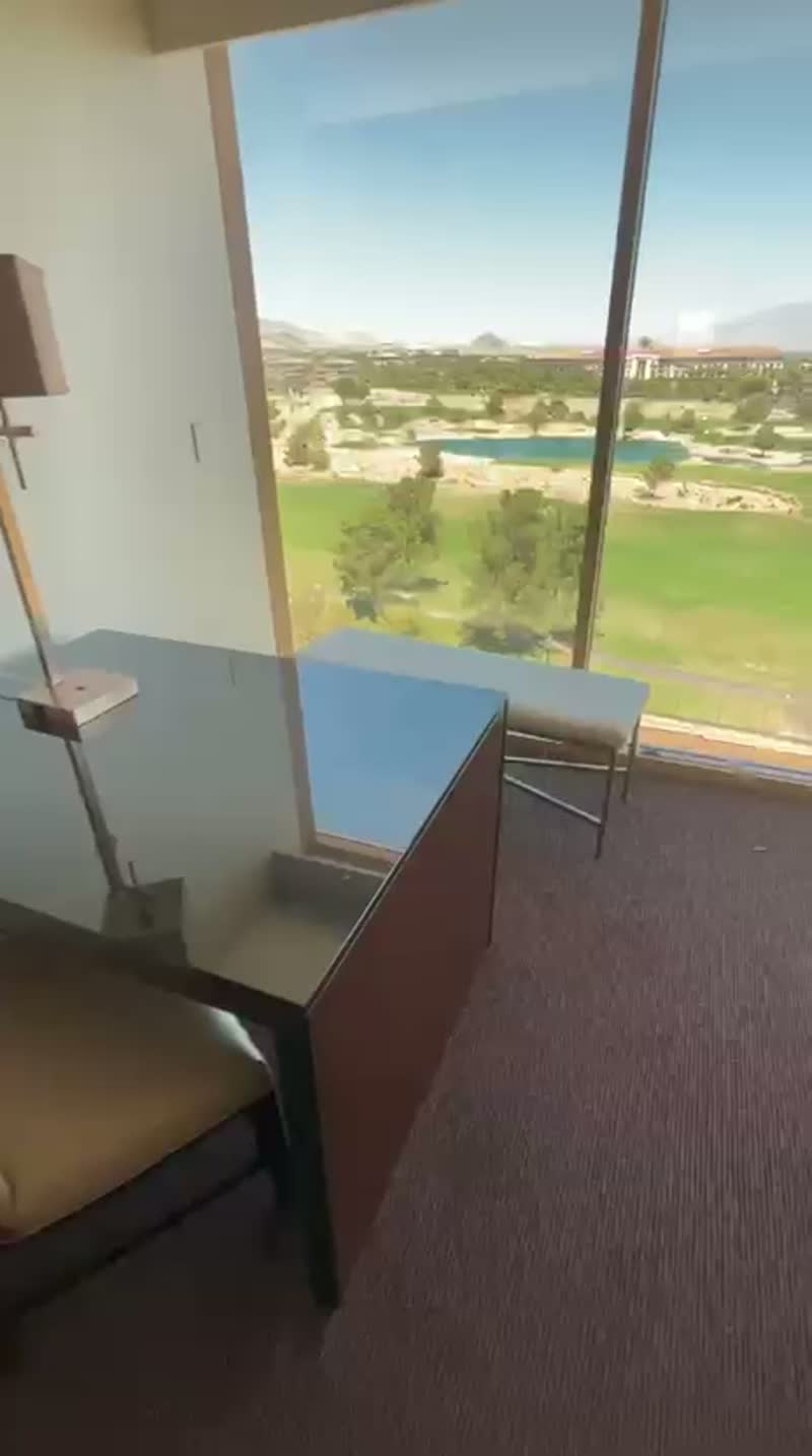 Walkthrough video of a classic guest room desk, seating and window wall