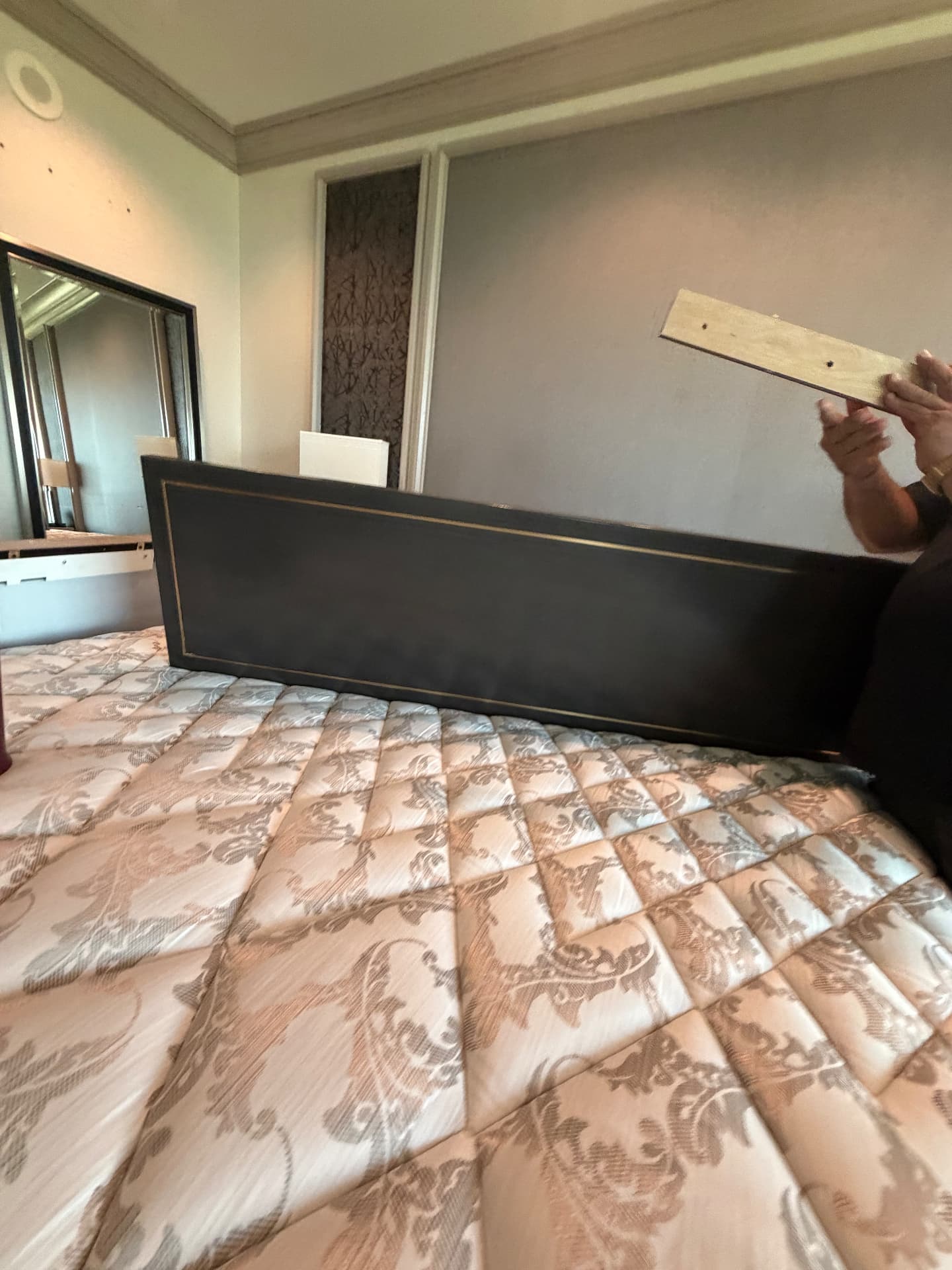Upholstered suite headboard panel with brass inlay detail