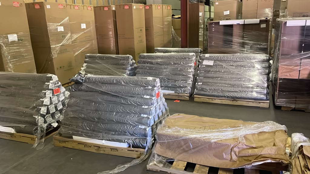 Wrapped pallets of box springs, mattresses and boxed room goods