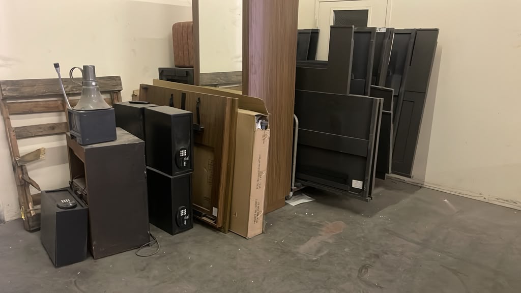 Room safes, doors, headboards and bath panels staged for pickup