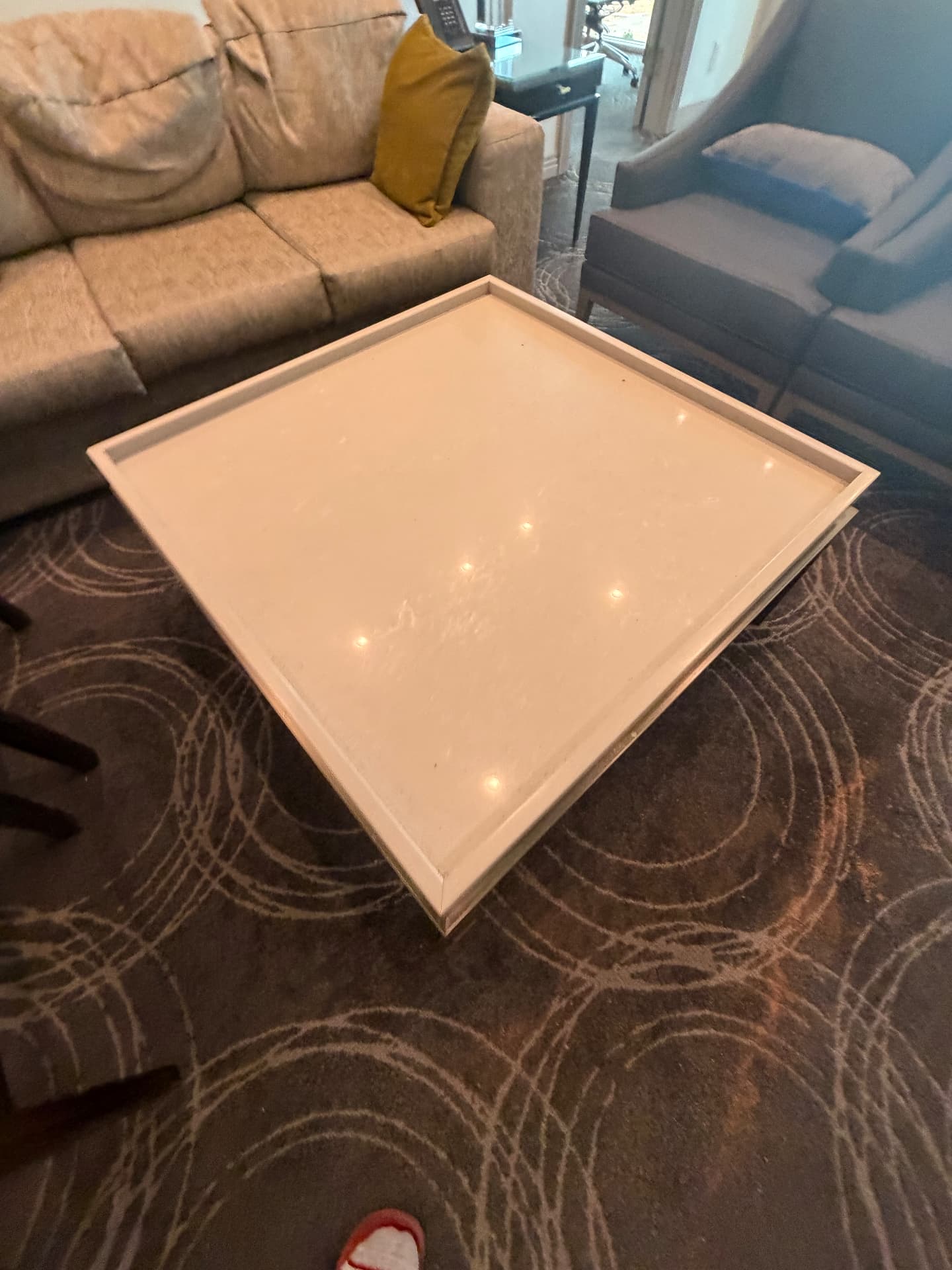 Stone-top coffee table with metal base from the suite living area