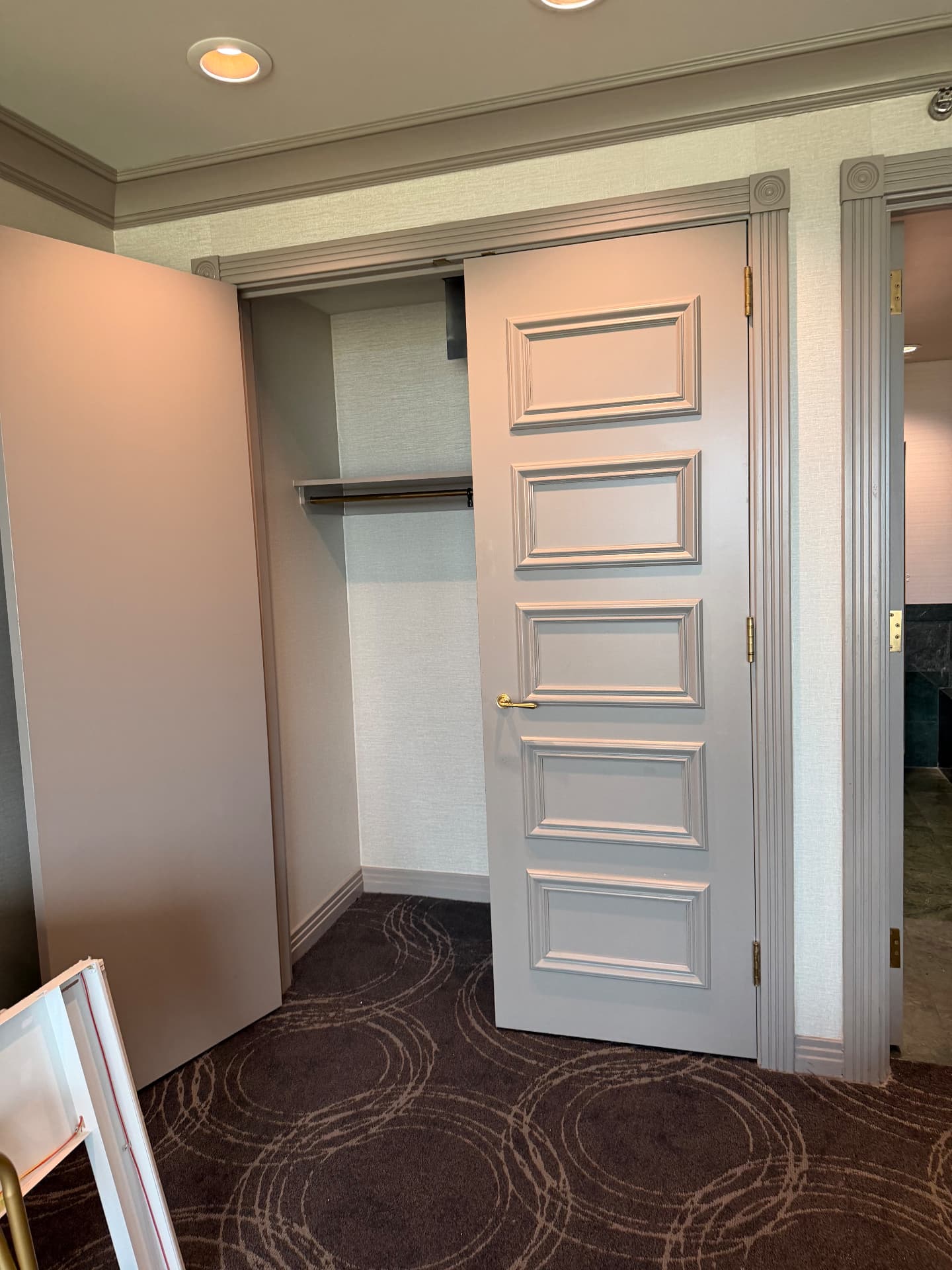 Suite closet with five-panel door and brass hardware