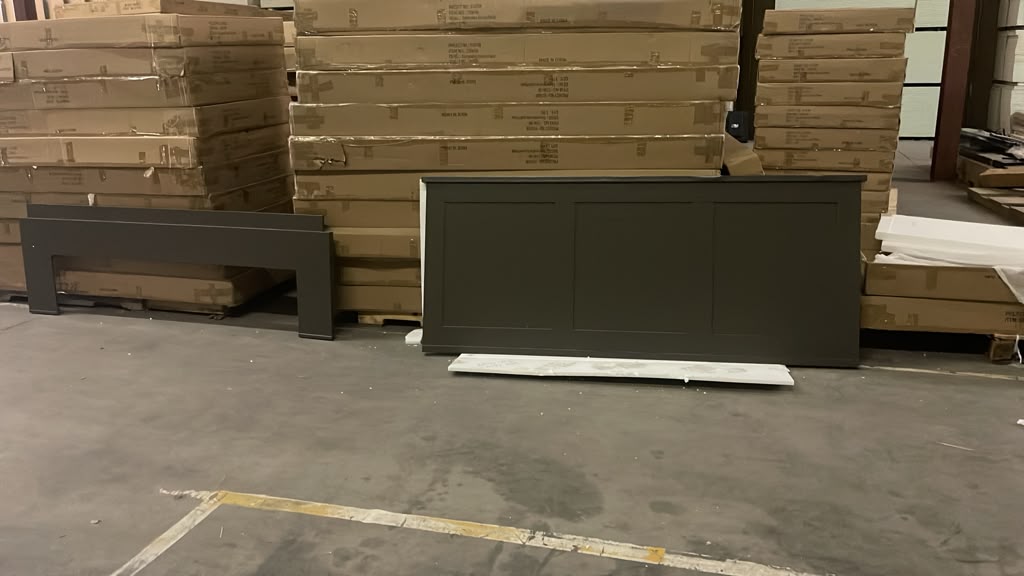 Brand-new case goods and bed frame with pallets of boxed replacements